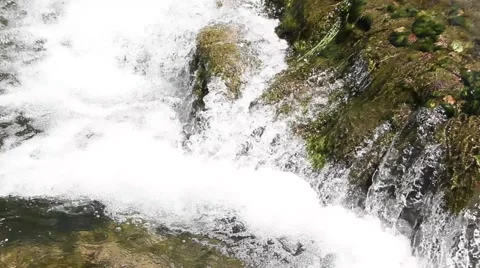 Stream of water by a waterfall Видео 47994367