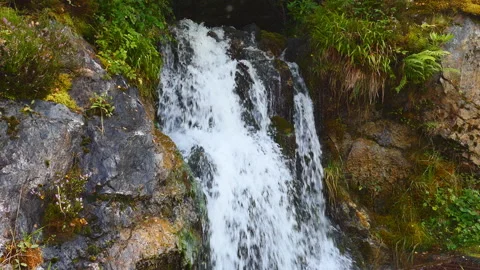 A stream of waterfall in the mountains. Stock Footage 112683308