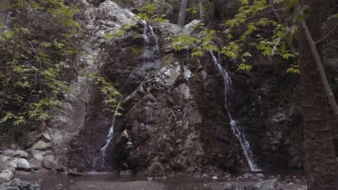 Stream of waterfall water cascading down mountain rock Stock Footage 148244116