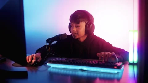 Streamer gamer playing e-sport video game online competition. Young boy chat   Stock Footage 260907962