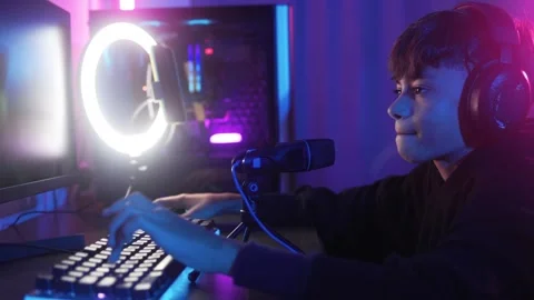 Streamer gamer playing e-sport video game online competition. Young boy chat wit Stock Footage 260907979