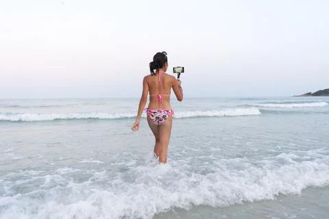 Streamer getting into the sea while performing live during the full moon party Stock Photos