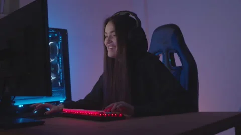 Streamer girl playing computer game talking and laughing Stock Footage 197472812
