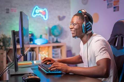 Streamer young man professional gamer play online games computer with headphones Stock Photos