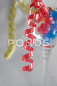 Streamers in a glass of martini Stock Photos