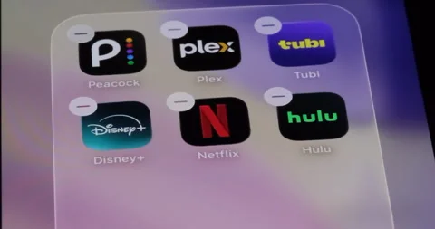 Streaming apps on phone screen. Peacock, Plex, Tubi, Disney+, Netflix, Hulu. Vídeos de archivo 341863826