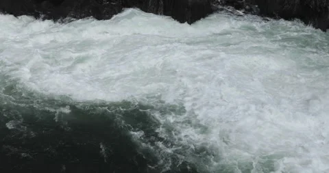 Streaming current wit foam in mountain river near hydroelectric power station. Stock Footage 136340812