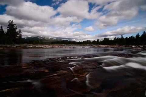 Streaming river with rocks in the foreground and moving clouds, Setesdal, Norway Video stock 81255049