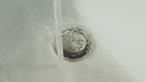 Streaming running water in sink, going down the drain in bathroom Stock Footage 159485425