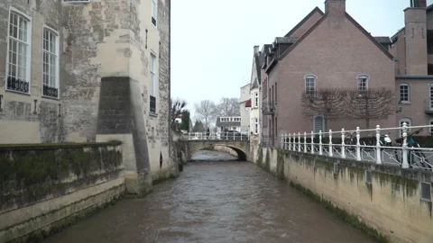 Streaming Water With a Small Bridge, Crossing Cars And People Taking A Selfie Stock Footage 130676635