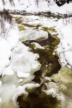 A streaming winter river between ice and snow, in the mountains of Setesdal Stock Photos