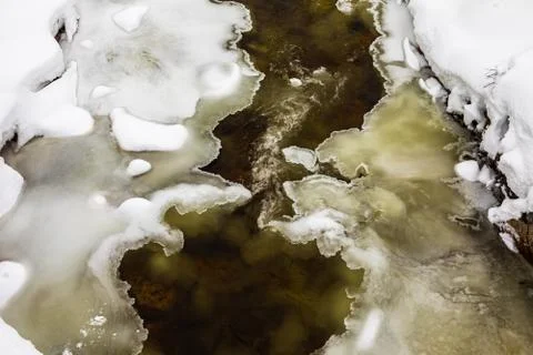 A streaming winter river between ice and snow, in the mountains of Setesdal Stock Photos