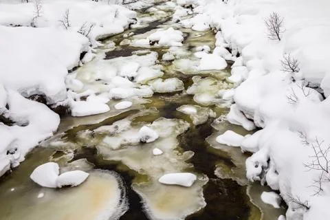 A streaming winter river between ice and snow, in the mountains of Setesdal Stock Photos