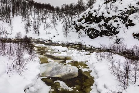 A streaming winter river in the mountains of Setesdal, Norway. River is Stock Photos