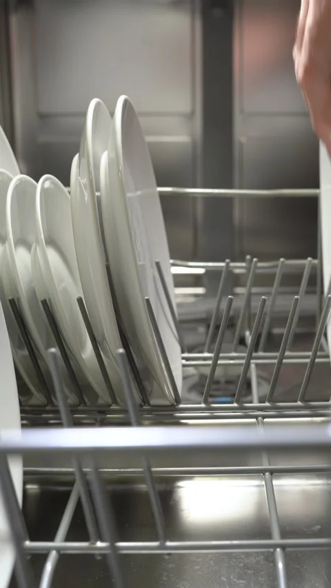 Streamlined Kitchen Efficiency: Loading the Dishwasher Stock Footage 274390121