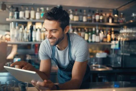 Streamlining small business tasks with smart tech. Shot of a young man using a Stock Photos