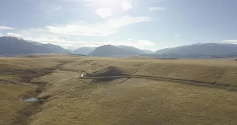 Streams and a Small Pond dot the Grassy Foothills, Aerial Drone Shot Stock Footage 281768376