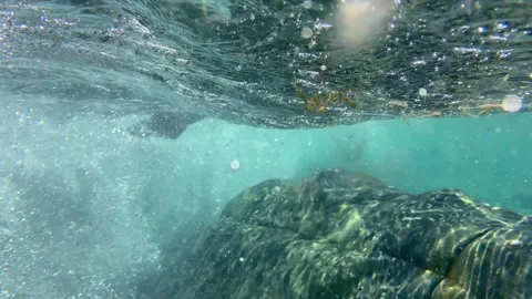 Streams of bubbles move rapidly in various directions as underwater turbulence Stock Footage 315970381