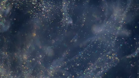 Streams full of tiny bokeh gold glittering bubbles are moving randomly and Stock Footage 107724861