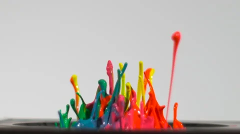 Streams of neon paint splash up from a speaker in slow motion, isolated on white Stock Footage 63894971