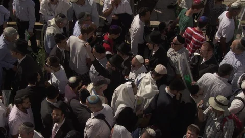 Streams of people entering and exiting the Western Wall in Jerusalem Stock Footage 86759338