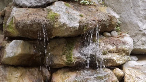 Streams of pure mountain water flow over the stones of the waterfall Stock Footage 118060041