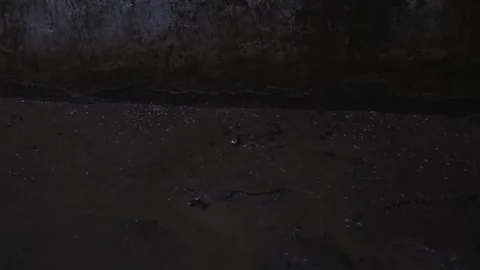Streams of rain flow along with the mud on the wall. Stock Footage 257895084