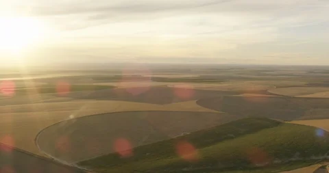 Streams of sunlight over yellow and green fields, helicopter aerial, drone Video stock 115337499