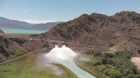Streams of water crash down to river from dam Stock Footage 208858668