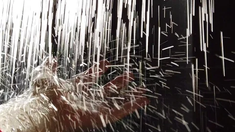 Streams of water fall on the hand, in drops of water reflected sunlight. Stock Footage 108132220