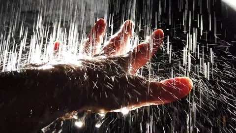 Streams of water fall on the hand, in drops of water reflected sunlight. Stock Footage 108132260