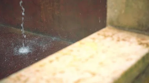 Streams of water hitting stone floor, slide Stock Footage 68063878