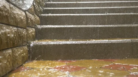 Streams of water pour down the steps of the stairs in the park during a pouring Stock Footage 91888269