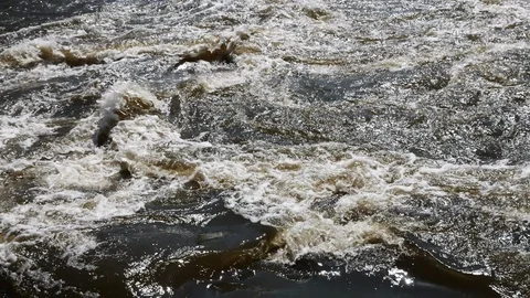 Streams of water on the river dam splashing out from the gateway and form waves Stock Footage 88552367