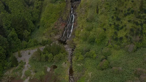 Streams of waterfall on steep slope. Top of mountain disappear in cloud. Aerial 스톡 동영상 117769894