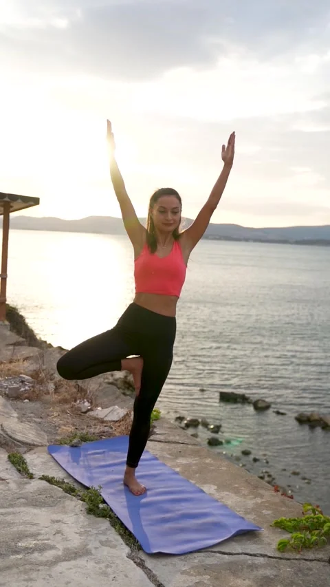 Strecthing yoga pose on the beach, Urla, Turkey - September 27, 2022 Stock Footage 327013955