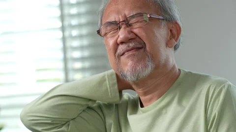 Streesed old male suffer while sit on sofa at home. Health care and insurance Stock Footage 219179210