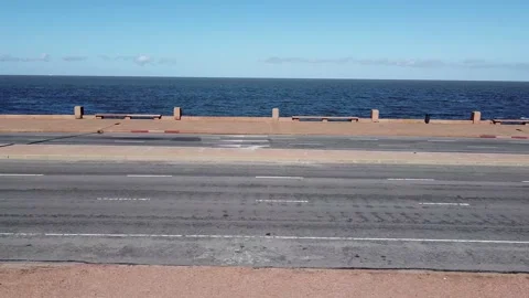 Street aerial side view of empty rambla promenade in Montevideo, Uruguay Stock Footage 213978543
