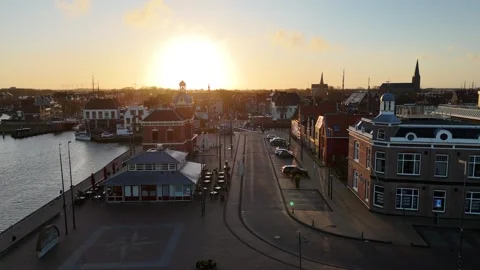 Street axis flight toward harbormaster tower in sunrise haze Stock Footage 331842314