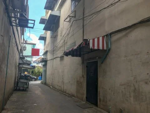 Street between building and empty wall in thailand Stock Photos