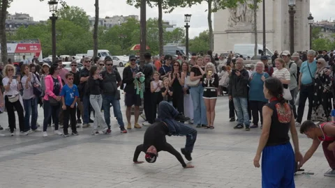 Street breakdancer performs an acrobatic headspin stunt for a crowd of people Stock Footage 336724349