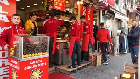 Street Cafe. Chefs of men do doners, kebabs - traditional street fast food. Stock Footage 88238848