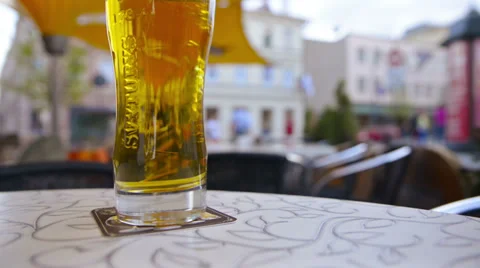 Street cafe. Mug of beer on the table. Video stock 37543358