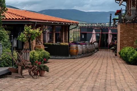 Street cafe in the old town without people, wine barrels stand in a row Stock Photos
