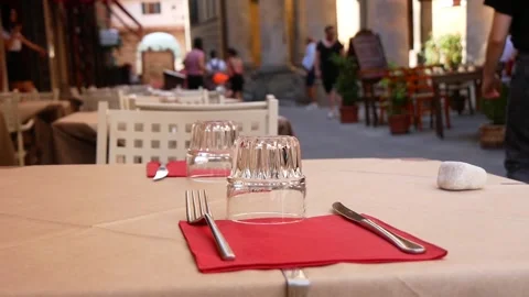 A Street Cafe Table Served With Glasses and Utensils for Two (Slow Motion) Stock Footage 244815285