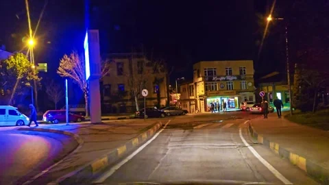 A street with a car driving down it Stock Footage 272993902