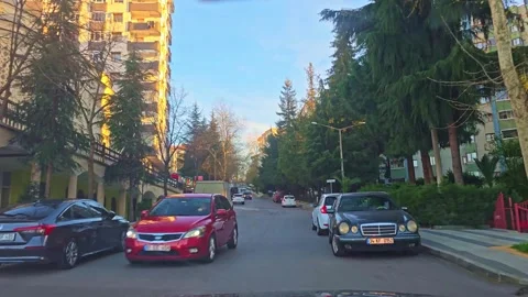 A street with a car driving down it Stock Footage 272996406