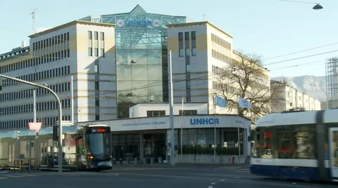 Street cars crossing in front of the UNHCR building in Geneva, Switzerland Stock Footage