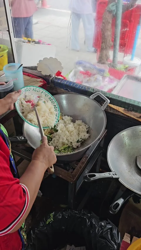 Street Chef Adding Steamed Rice into Hot Wok for Fried Rice Preparation Stock Footage 342982722