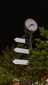 Street clock with pointer signs and arrows Stock Photos